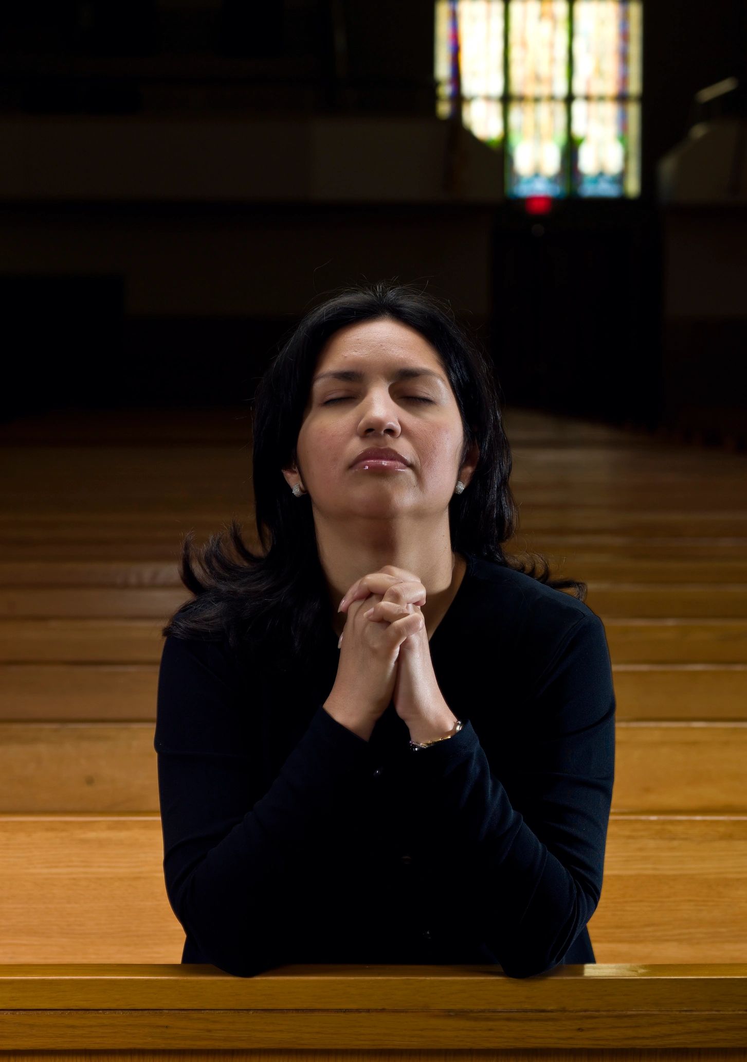 Woman praying in church